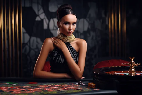 A stylish woman beside vibrant slot machines displaying glowing sevens, showcasing the variety of top slots at KOKOZINO.